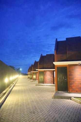 a row of houses at night with lights at Treehita Cabin Jogja in Sleman