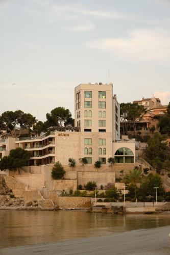 a building next to a body of water at Aethos Mallorca in Paguera