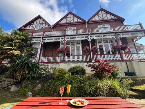 a table with a plate of food in front of a house at The Robin Hill in Torquay