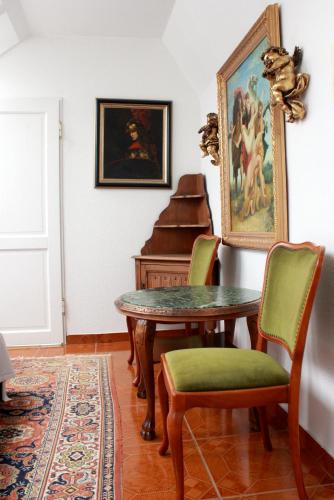 a dining room with a table and a piano at Rittergut Haus Laer in Bochum