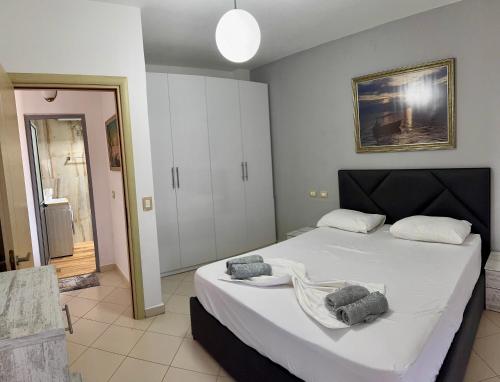 a bedroom with a bed with two towels on it at Beach Apartments Durres in Durrës
