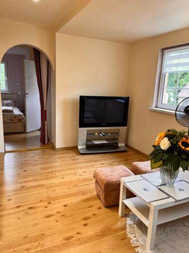 a living room with a large flat screen tv at U Piekarza za Piecem in Jarnołtówek