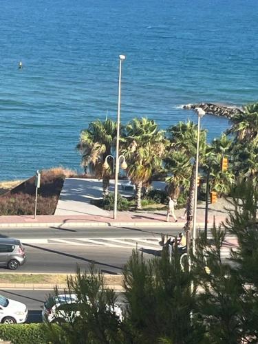 a view of a street with the ocean in the background at Benalmadena Suite Vistas panorámicas, 2 piscinas, Area infantil, Bar, Jardines y Tenis in Benalmádena