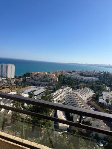 a view of a city with the ocean in the background at Benalmadena Suite Vistas panorámicas, 2 piscinas, Area infantil, Bar, Jardines y Tenis in Benalmádena