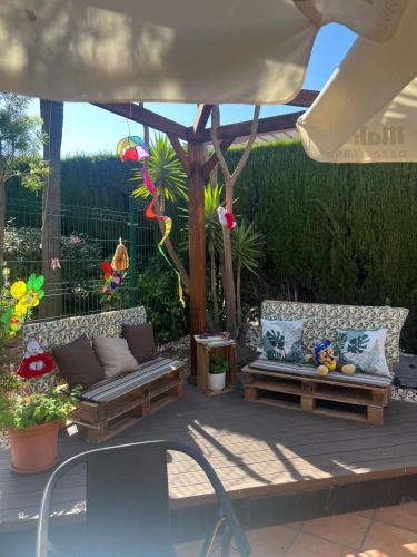 a patio with two couches sitting under a gazebo at Benalmadena Suite Vistas panorámicas, 2 piscinas, Area infantil, Bar, Jardines y Tenis in Benalmádena