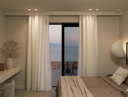 a bedroom with a bed and a view of the ocean at Sundara Estate, Exclusive Seaview Villa with Grand Pool & Direct Beach Access in Ratzaklíon