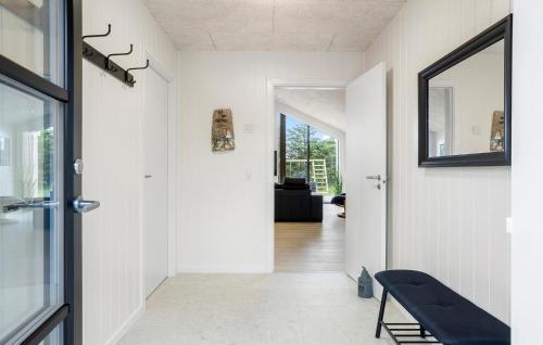 a hallway of a house with a mirror and a bench at Amazing Home In Sæby With Sauna in Sæby