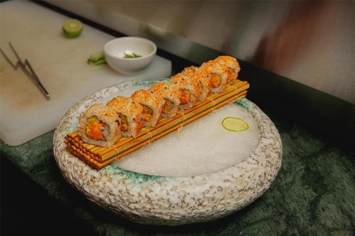 a plate of sushi on top of a table at Radisson Blu Hotel Ranchi in Rānchī
