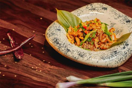 a bowl of food on a wooden table at Radisson Blu Hotel Ranchi in Rānchī