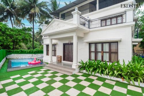 a house with a pool in front of it at EKOSTAY Luxe - Oceanic Villa in Alibaug