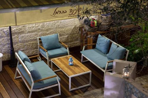 a group of chairs and a table on a patio at Carmel Pearl in Haifa