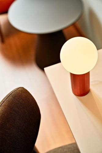 a close up of a table with a chair and lamp at URBANAUTS STUDIOS Minelli in Trieste