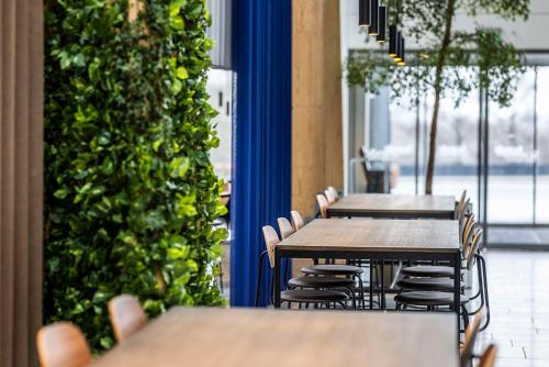 a row of tables and chairs in a restaurant at Scandic Opus Horsens in Horsens