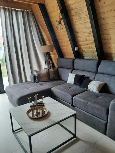 a living room with a couch and a table at Cozzy LUX apartment near the Airport Podgorica in Lajkovići