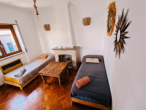 a living room with a couch and a table at Lisbon Soul Surf Camp in Cascais
