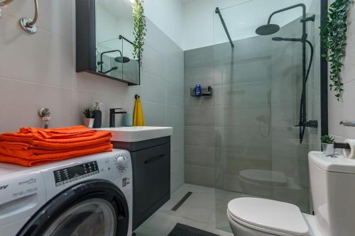 a bathroom with a washing machine and a shower at Studio 44 in Belgrade
