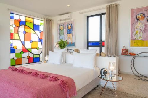 a bedroom with a large bed with a stained glass window at Dar Syada Boutique Hotel Marrakech in Marrakech