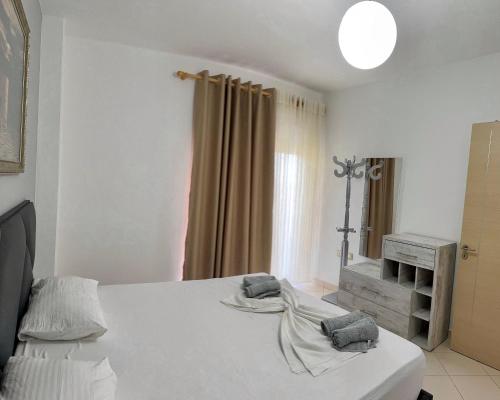a bedroom with a bed with two towels on it at Beach Apartments Durres in Durrës