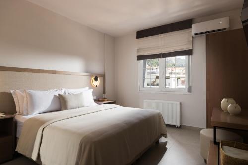Ένα ή περισσότερα κρεβάτια σε δωμάτιο στο Meteoron Suites