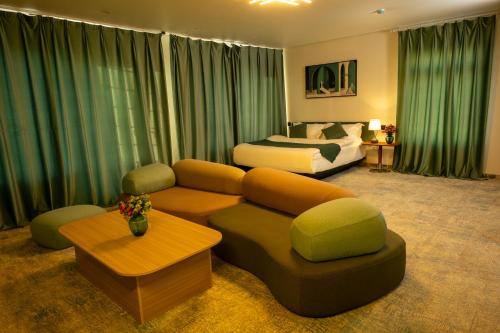 a living room with a couch and a bed at MSInternational Hotel in Ulaanbaatar