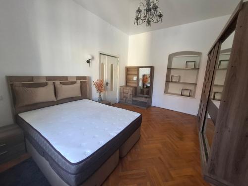 a bedroom with a large bed and a mirror at NaNa in Itʼkhvisi