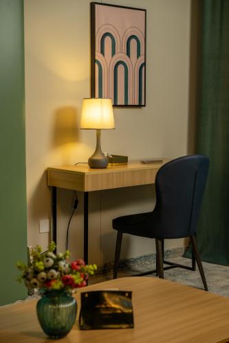 a desk with a chair and a lamp on a table at MSInternational Hotel in Ulaanbaatar