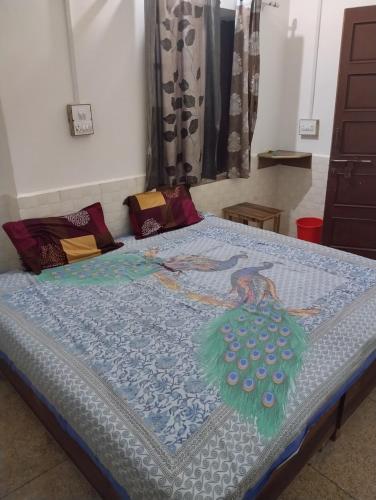 a bed with a quilt on top of it at Balaji guest house in Jāmb