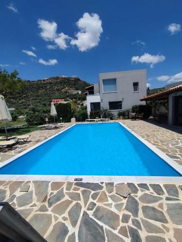 een blauw zwembad voor een huis bij IRIDA Studios Hotel & Pool in Plakias