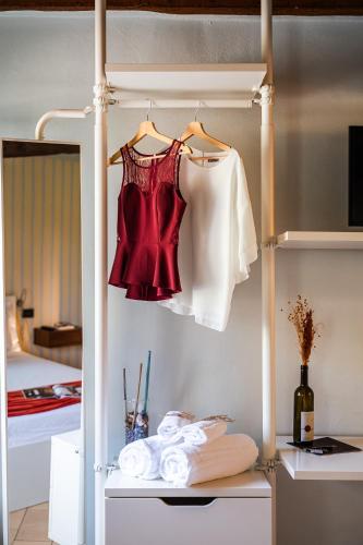 a wardrobe with a red dress and a bed at Emilio's Rooms in Levizzano Rangone