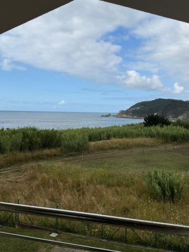 a view of the ocean from a train window at Ca Mestral Espasante San Antonio - Vistas espectaculares in Porto de Espasante