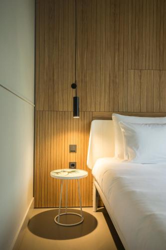 a bedroom with a bed and a small table next to it at Conscious Hotel Westerpark in Amsterdam
