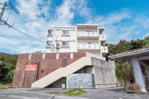 a building with a staircase in front of it at unito villa OKINAWA Koza in Okinawa City