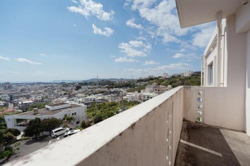a balcony with a view of a city at unito villa OKINAWA Koza in Okinawa City