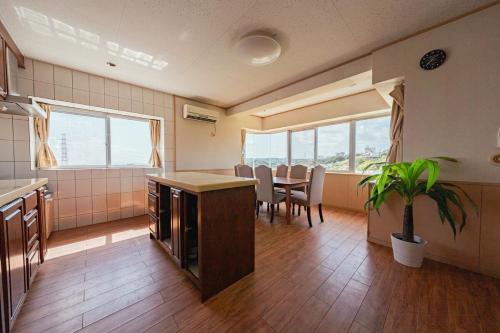 a kitchen and dining room with a table and chairs at unito villa OKINAWA Koza in Okinawa City