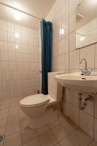 a bathroom with a toilet and a sink at unito villa OKINAWA Koza in Okinawa City