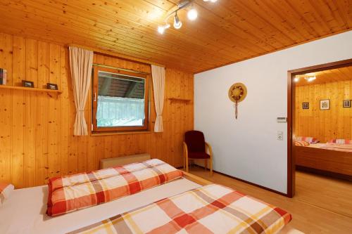 a bedroom with a bed in a wooden room at Untermetzgersbauernhof in Alpirsbach