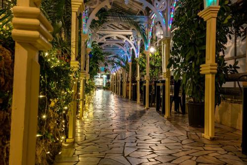 a hallway with plants and lights in a building at Apartament Gold - Góry Sowie - Głuszyca in Głuszyca