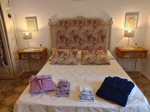 a bedroom with a large bed with two night stands at B&B Luxury Villa Olimpia Home Restaurant in Selva di Fasano