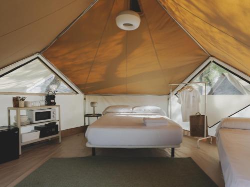 a bedroom with a bed in a tent at wecamp Jávea in Jávea