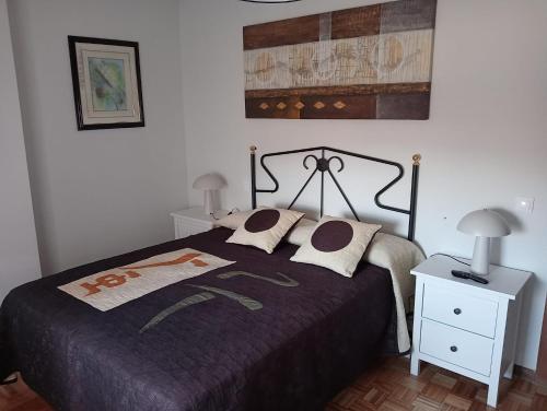 a bedroom with a bed and a table with a lamp at Chillout La Rioja in Haro