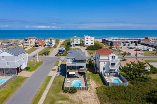 an aerial view of a city with houses and the ocean at Salty Vibes in Nags Head