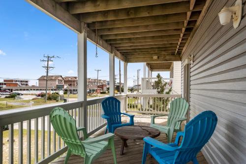 four chairs and a table on a porch at Salty Vibes in Nags Head