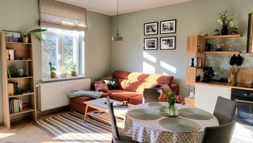 a living room with a table and a couch at Apartamenty EverySky Kowary, Cozy Home z widokiem na góry i windą in Kowary