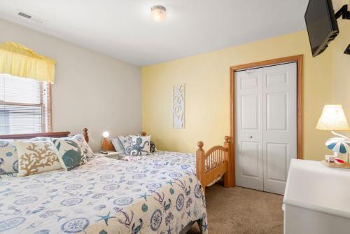 a bedroom with two beds and a door at Salty Vibes in Nags Head