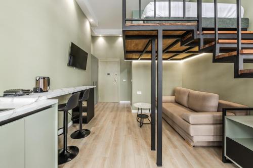 a living room with a couch and a loft at Amel's Rooms in Tirana