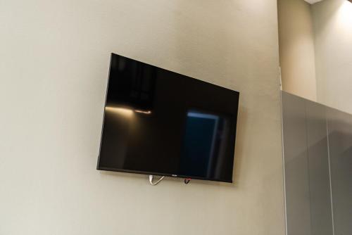 a flat screen tv hanging on a wall at Amel's Rooms in Tirana