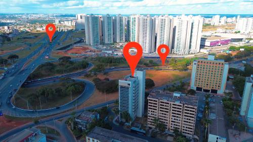 a city with orange markers on a city with buildings at Flat em Hotel, Até 4 Hóspedes, Piscina, Garagem , Jr Catito in Brasilia