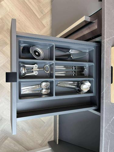 a black drawer with silver tools in it at Luise LuXe Suites in Tallinn