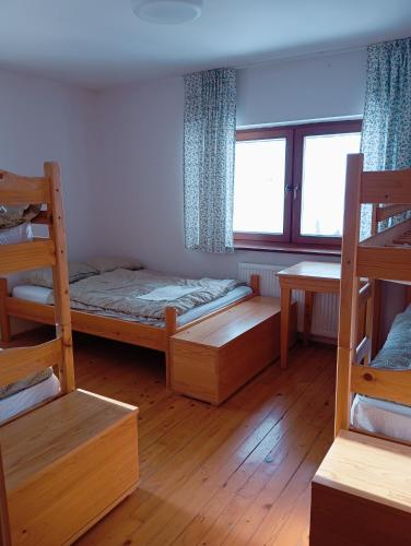 a room with two bunk beds and a window at DOMŽALSKI DOM na Veliki Planini in Stahovica
