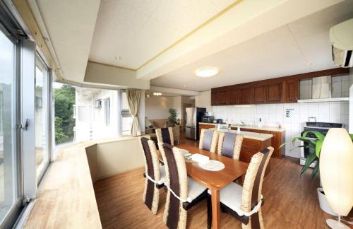 a kitchen and dining room with a table and chairs at unito villa OKINAWA Koza in Okinawa City